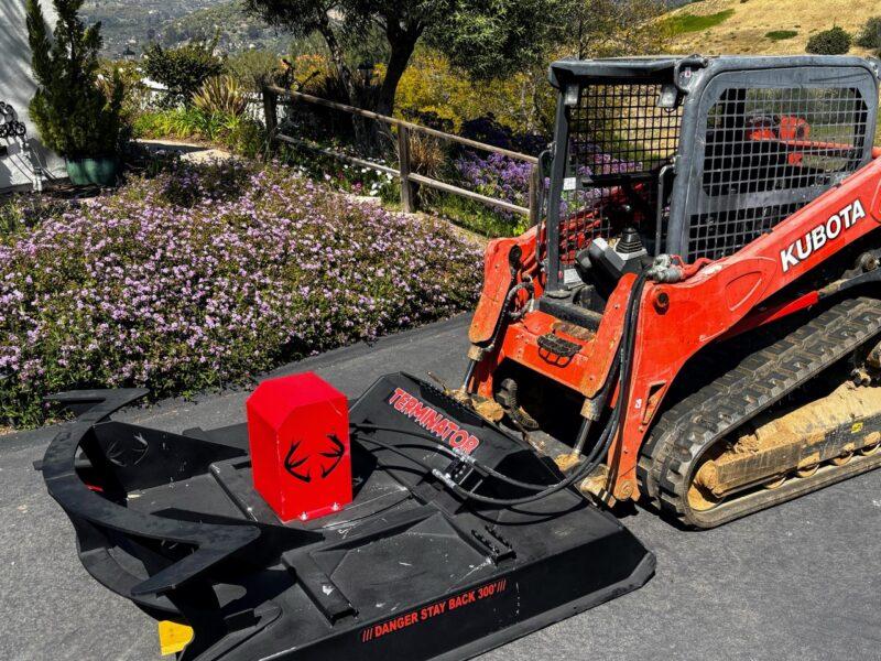 Brush cutter attachment on Kubota track loader