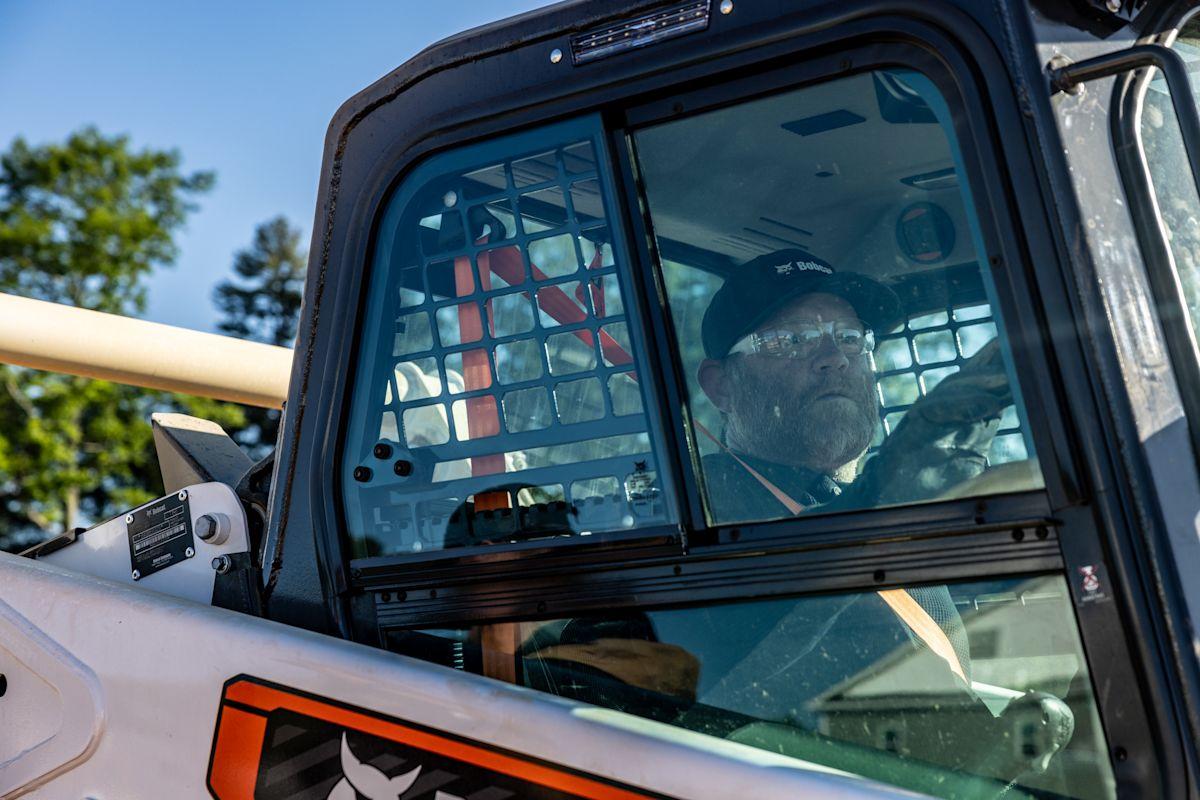 Operator in the enclosed Bobcat T66 cab